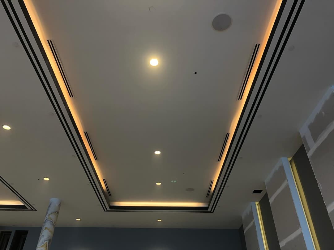 Modern ceiling design showcasing recessed lighting and elegant architectural details.